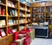 A room filled with lots of shelves filled with books
