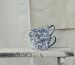 white and blue floral ceramic mug on white table